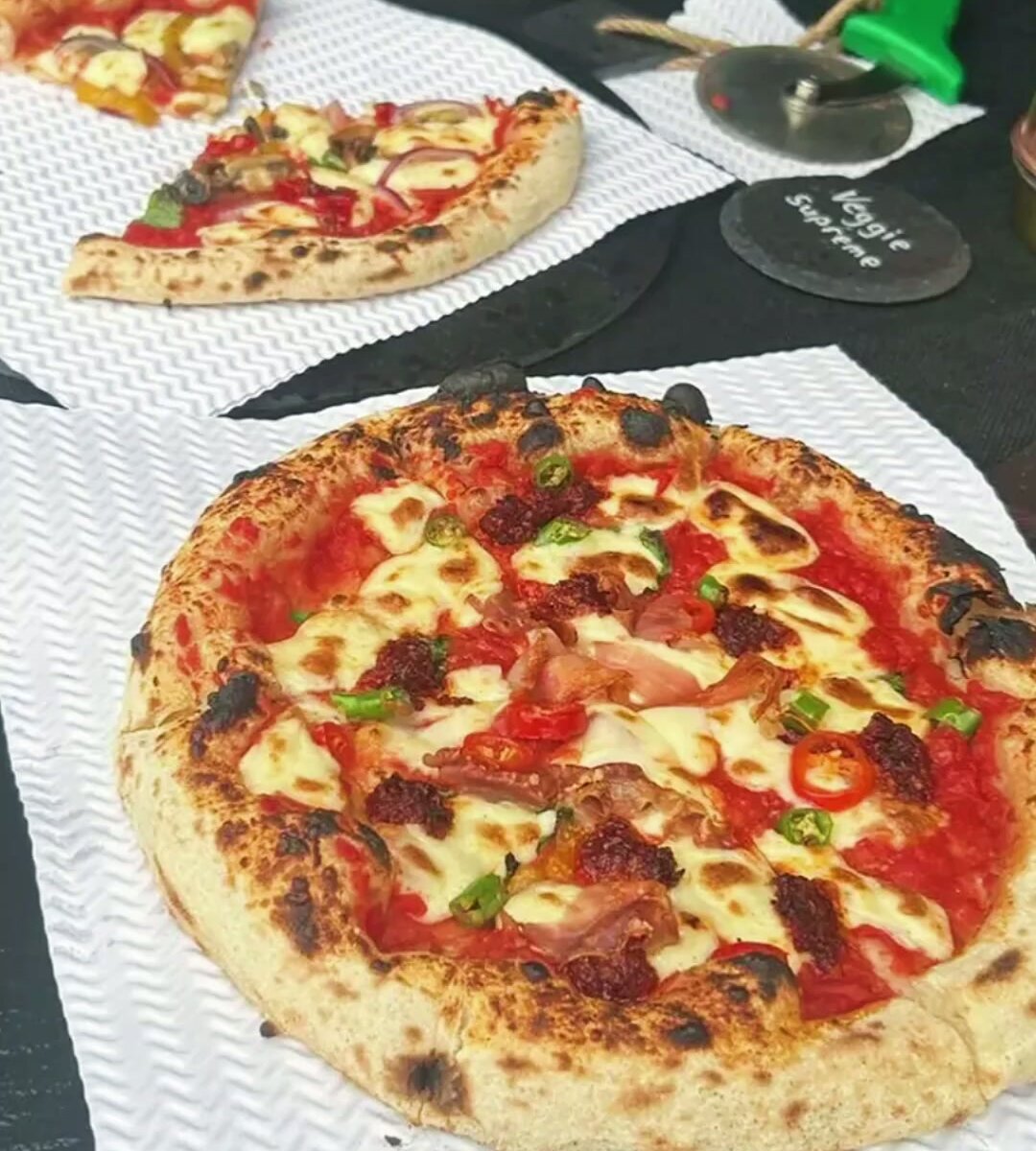 Stone-baked pizza leaving the Olio Pizza Box oven